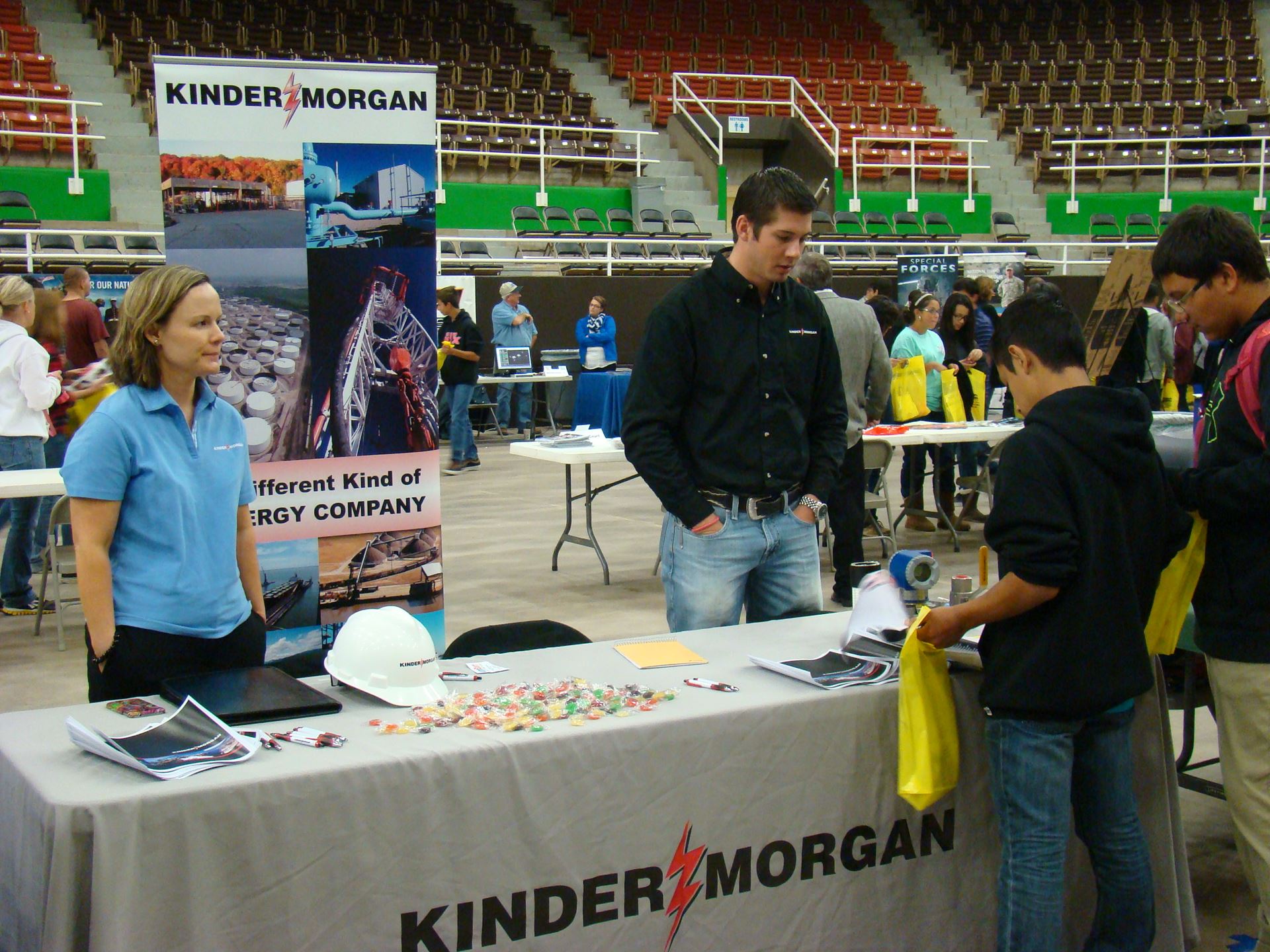 Individuals at Kinder Morgan booth.